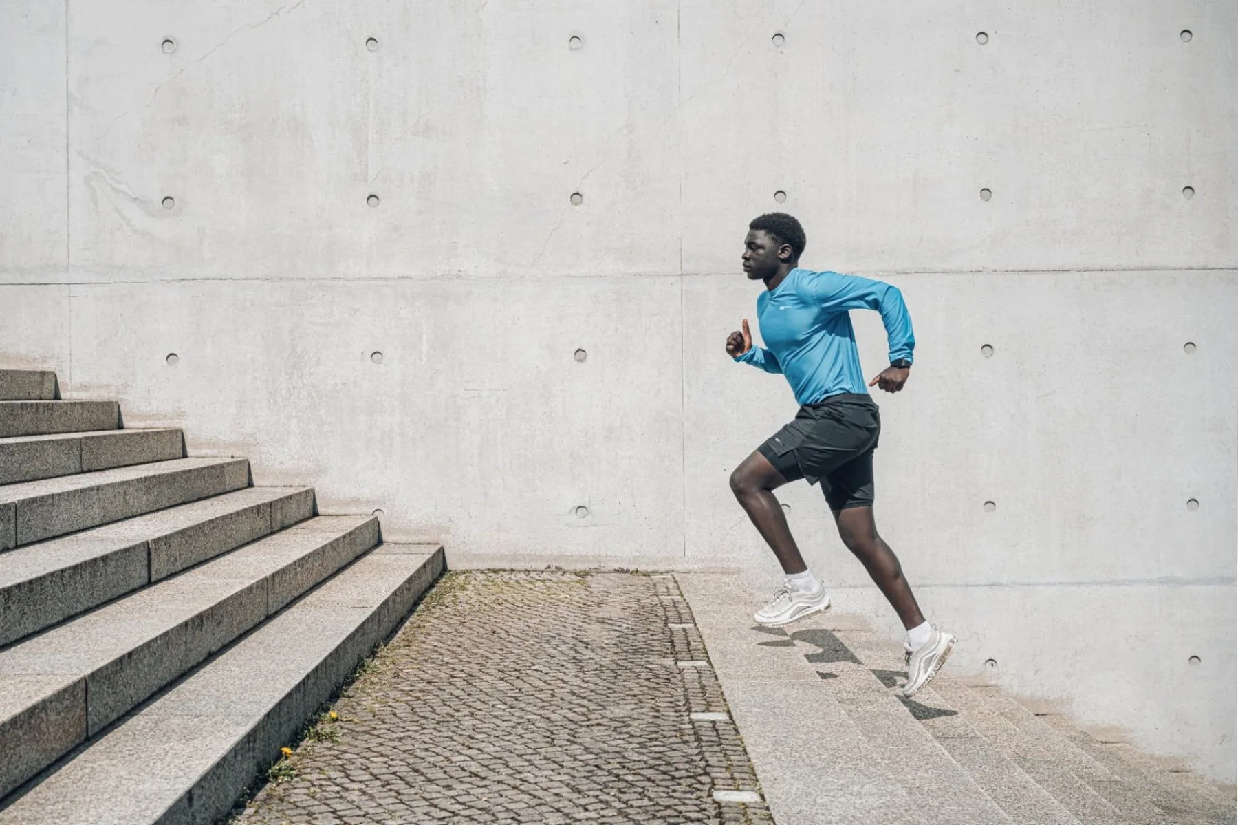 Runner in Roc Street activewear moving through a concrete setting